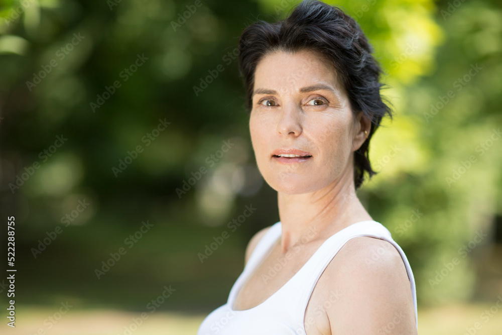 Summer lifestyle portrait smile middle aged woman looking at camera relaxes outdoor. Enjoying the little things. spends time in nature in summer. Summer lifestyle portrait smile middle aged woman looking at camera relaxes outdoor. Enjoying the little things. spends time in nature in summer.