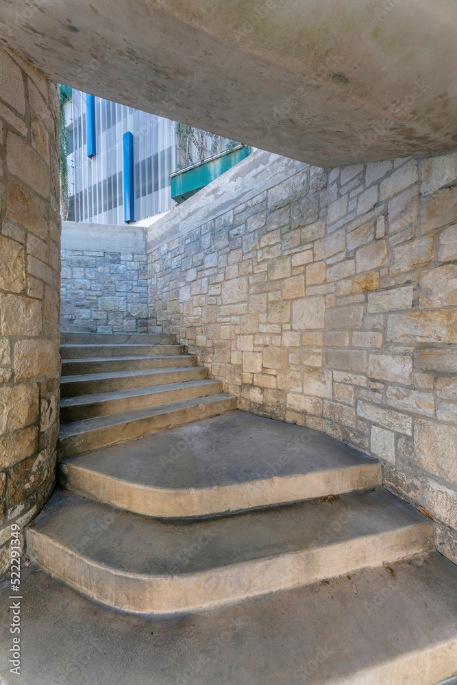 Staircase under a concrete ceiling with stone block walls at San Antonio, Texas