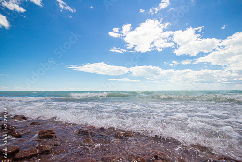 waves crashing against the rocks during the surf on the huge Balkhash lake, on a great sunny summer day