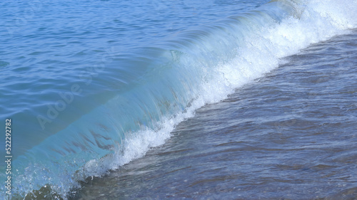 Powerful Ocean blue waves with white foam. Restless water. Beautiful blue water background. Bubbling Sea wave. High wave in the sea. Turbulent the sea. Stormy ocean with big restless waves 