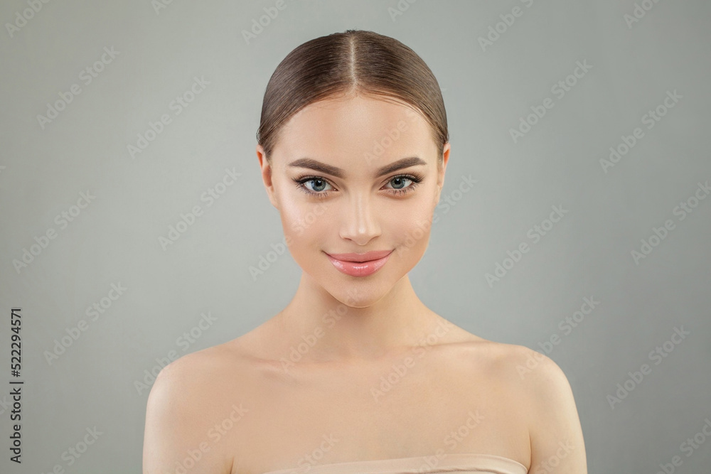 Beautiful female face. Smiling woman with clean shiny skin. Facial treatment, skincare and spa concept Beautiful female face. Smiling woman with clean shiny skin. Facial treatment, skincare and spa concept