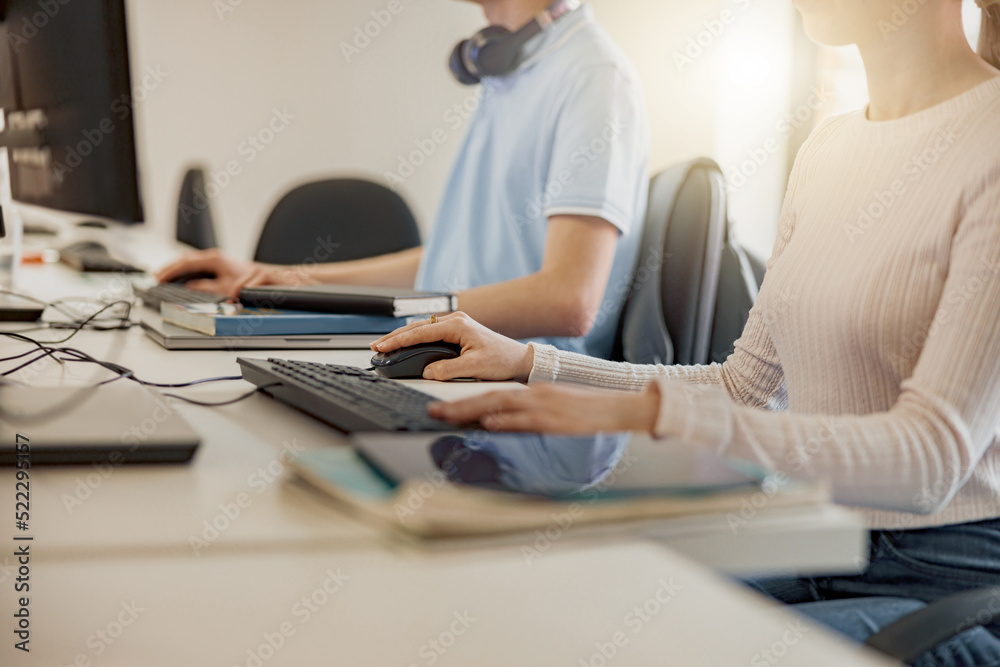 Close up of university student using computer studying in computer room Close up of university student using computer studying in computer room