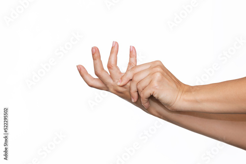 Cropped shot of a young woman holding palm's fingers in her hand isolated on a white background. Numbness of the limbs. Injuries, Pain in the joints of the hands, carpal tunnel syndrome, neuralgia photo