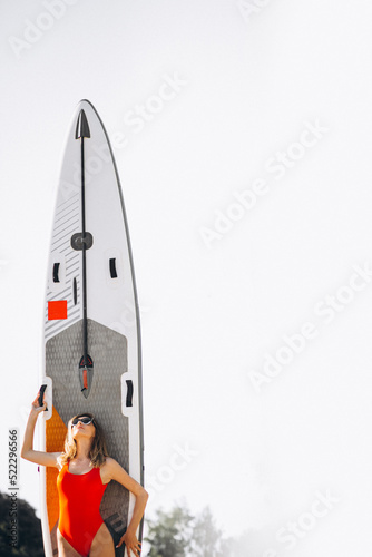 Photography Woman with surfing board