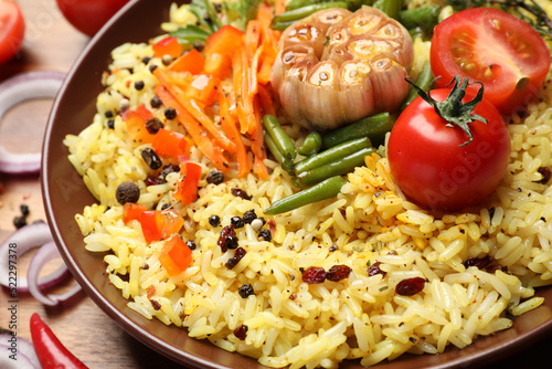 Tasty rice pilaf with vegetables on table, closeup