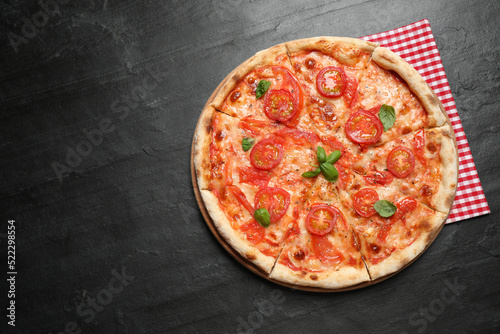 Delicious pizza Margherita on dark grey table, top view. Space for text