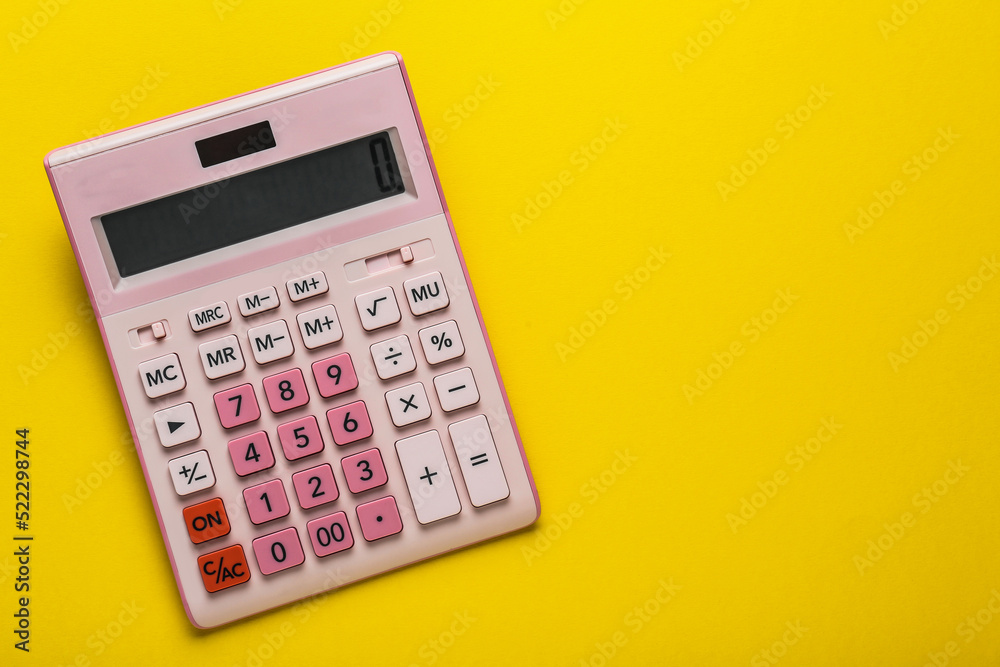 Pink calculator on yellow background, top view. Space for text Pink calculator on yellow background, top view. Space for text