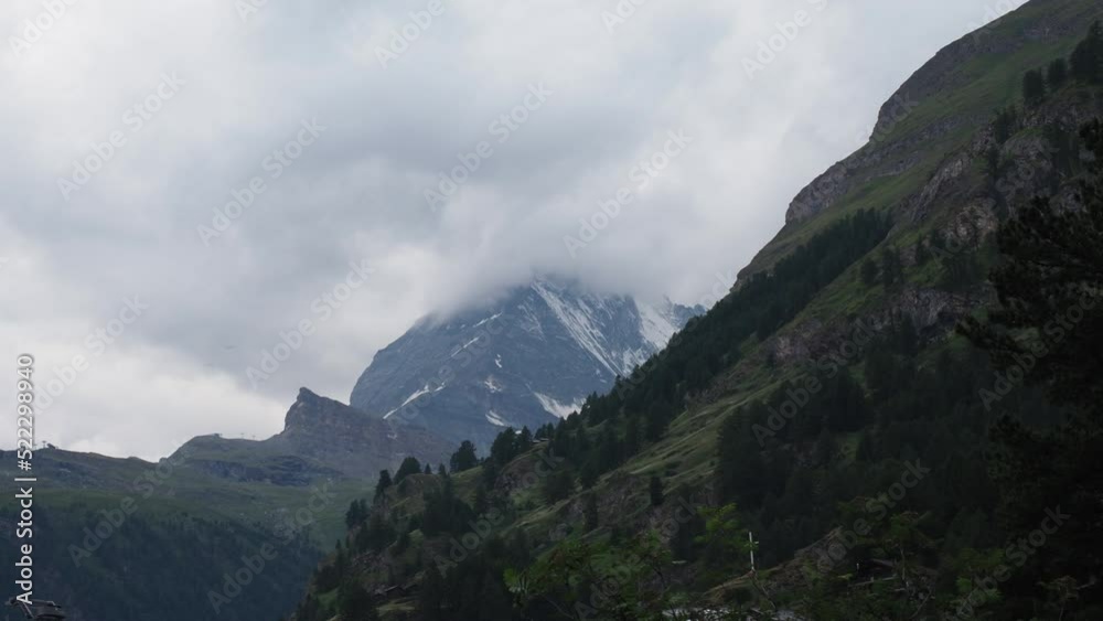 Matterhorn Time lapse 4k video. Beautiful nature of Matterhorn mountain Zermatt Switzerland Alps. Moving cloud moment before rain. View from Zermatt city. Matterhorn peak with clouds cover. Timelapse.