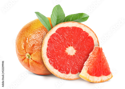 Tasty ripe grapefruits and green leaves on white background