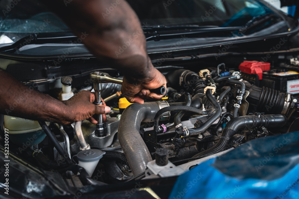 Auto mechanic doing car maintenance. Auto mechanic doing car maintenance.