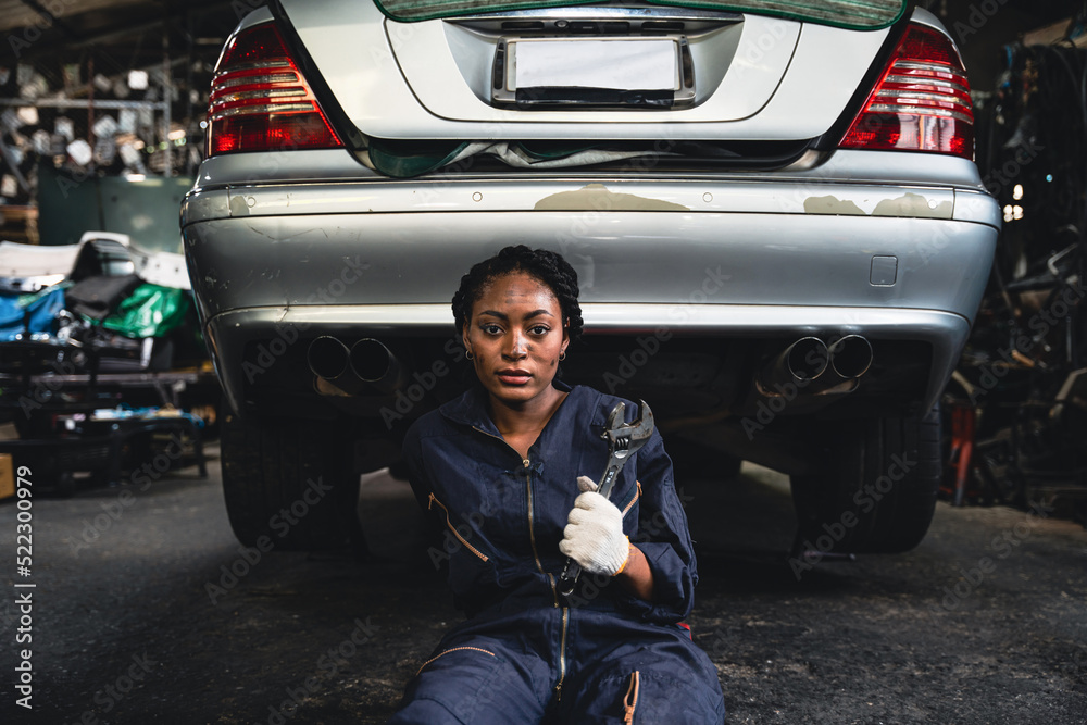 Woman mechanic fixing the car suspension. Woman mechanic fixing the car suspension.