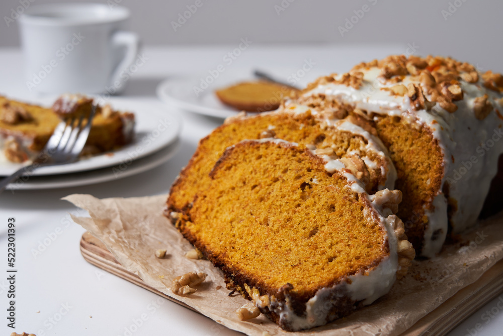 Slices of homemade carrot cake with sugar frosting and nuts. Food concept