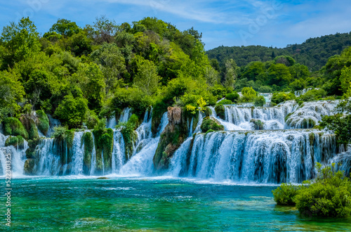 Sun breaks through to render blue water at the cascades of Krka National Park