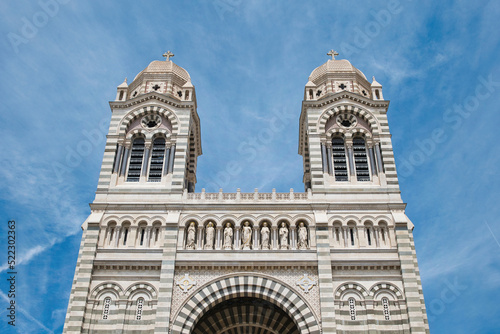 Front view of the two towers of the Marseille Cathedral in front of a blue summer sky. Old, beautiful, romanesque-style cathedral in Marseille, France. Sightseeing in southern France. 