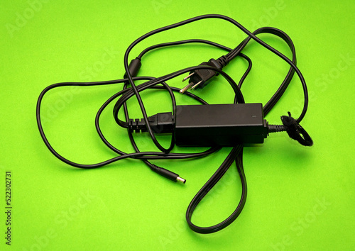 Computer battery charger on green background