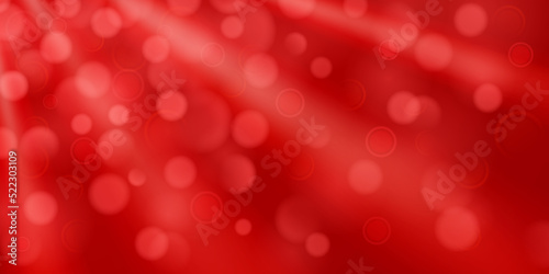 Abstract background in red colors with diverging rays of light and small translucent circles with bokeh effect