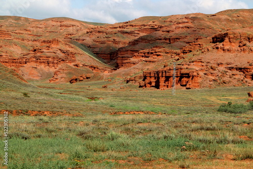 Landscape with red mountains Narman Peribacalari, formed due to erosion and weathering, against the blue sky with clouds, near the city of Erzurum, in the region of Eastern Anatolia, Turkey photo