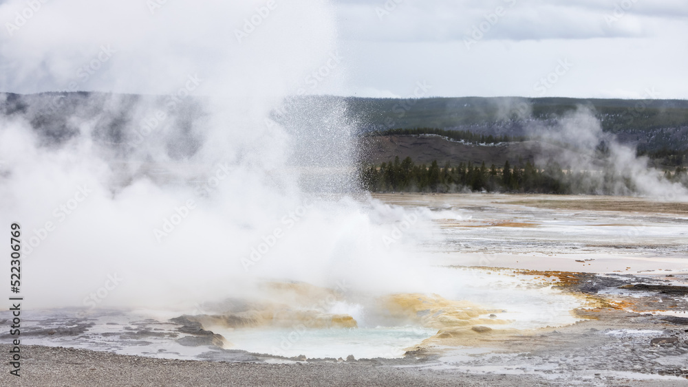 Hot spring Geyser with colorful water in American Landscape. Yellowstone National Park, Wyoming, United States. Nature Background.