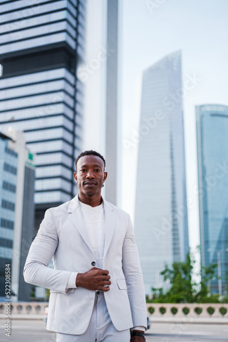 Successful businessman dressed in white suit in financial district