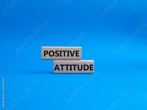 Positive attitude symbol. Concept words Positive attitude on wooden blocks. Beautiful blue background. Business and Positive attitude concept. Copy space.