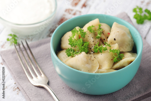 Russian national dish pelmeni served in a plate	 photo