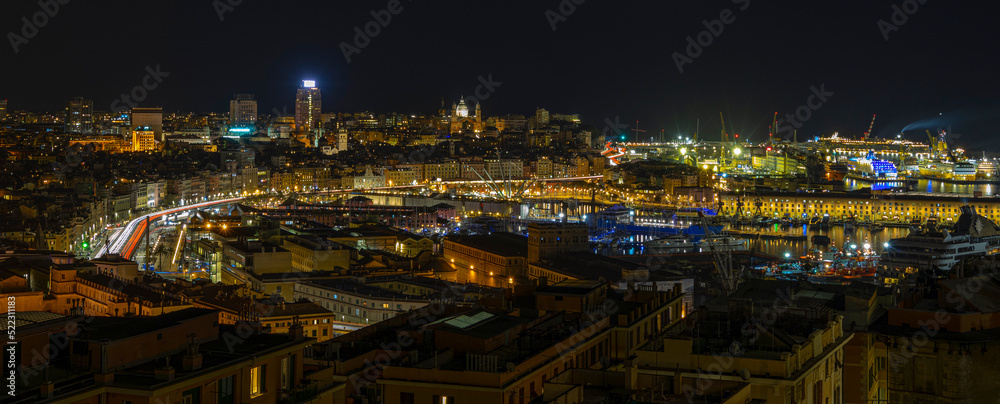 Fototapeta premium Panoramic view of Genoa at night with the causeway and the buidings of the historic center, Italy