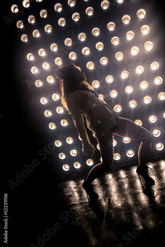 Sexy girl dance on front of spot light wall with smoke