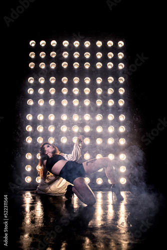 Sexy girl dance on front of spot light wall with smoke