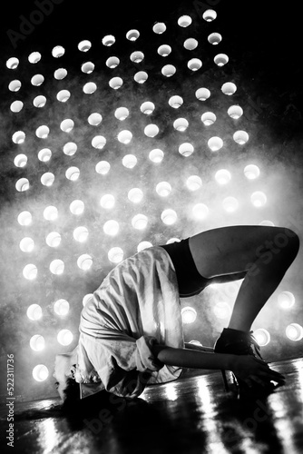 Sexy girl dance on front of spot light wall with smoke