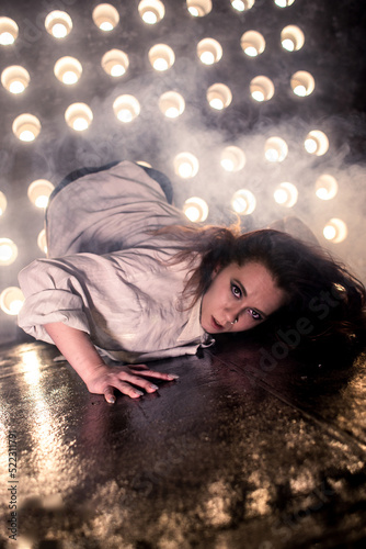 Sexy girl dance on front of spot light wall with smoke