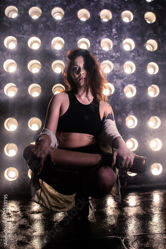 Sexy girl dance on front of spot light wall with smoke