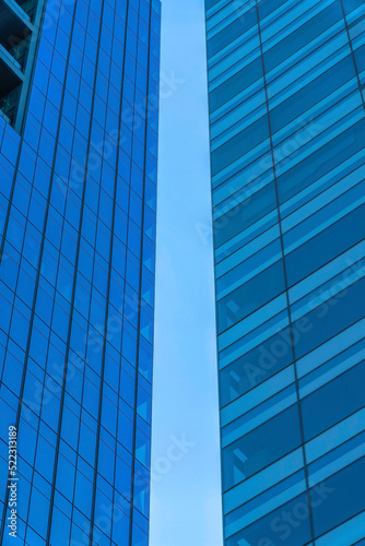 Clear sky in between the two tall buildings with glass walls- Austin, Texas