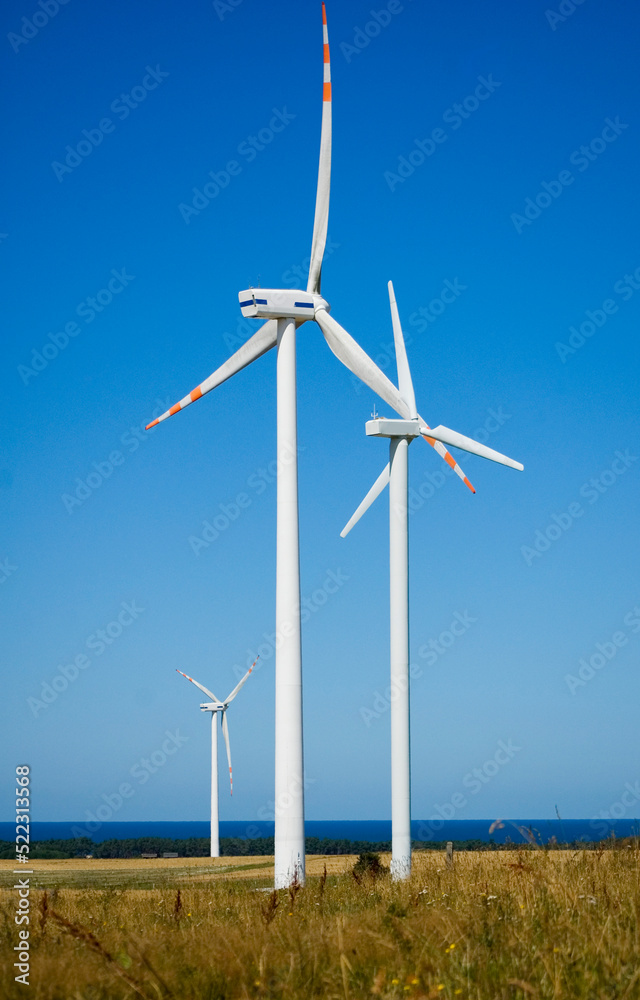 Windmill for electric power production against blue sky. Windmill for electric power production against blue sky.