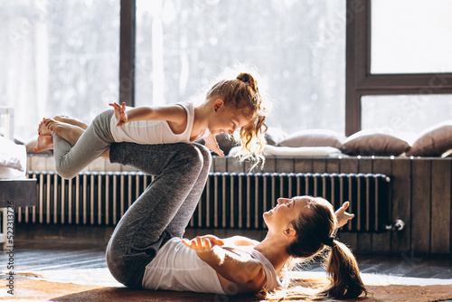 Mother and daughter yoga at home