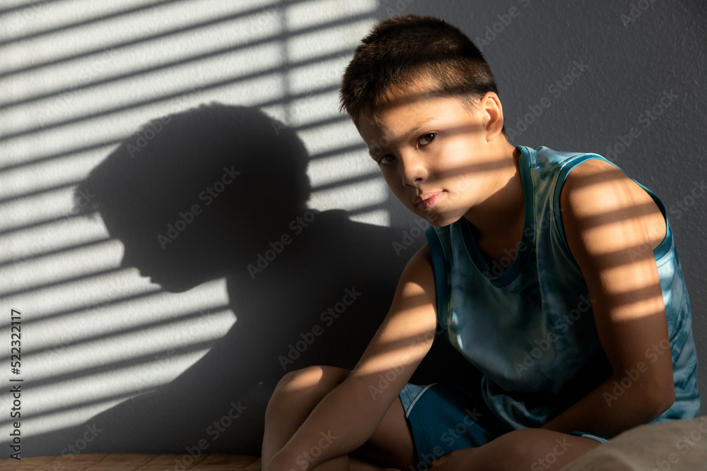 Lifestyle portrait of child sitting in the room at sunlight, childhood memories Lifestyle portrait of child sitting in the room at sunlight, childhood memories