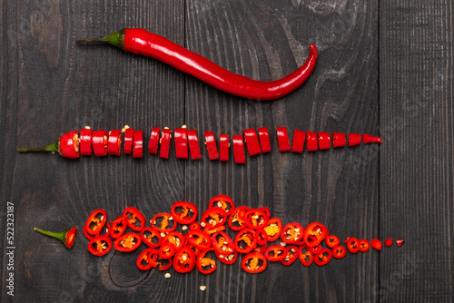 hot chili peppers chopped on a wooden table top view
