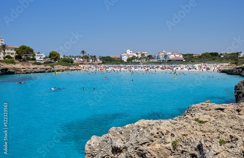 Menorca, Spain: Cala en Bosch beach minorca . Cami de cavalls. Beautiful minorca beach with small hotel in the background. white sand and turquoise water