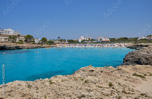 Menorca, Spain: Cala en Bosch beach minorca . Cami de cavalls. Beautiful minorca beach with small hotel in the background. white sand and turquoise water © Matteo