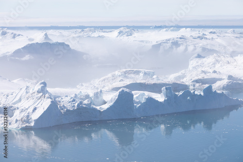 Climate change and global warming. Icebergs from a melting glacier in Ilulissat Glacier, Greenland. The icy landscape of the Arctic nature in the UNESCO world heritage site. © Michal