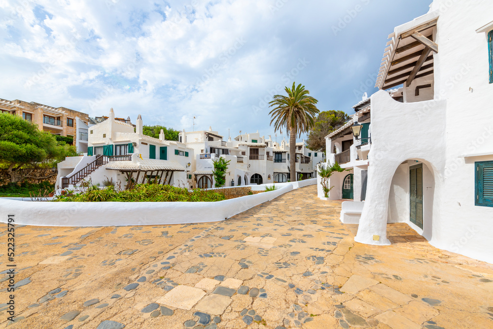 The whitewashed seaside village of Binibeca Vell, Spain on the Mediterranean island of Menorca.	