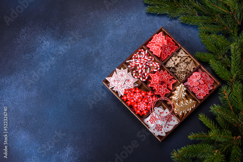 Christmas toys in white and red in a wooden sectional box against a dark concrete background
