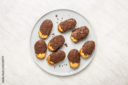 Fotografija Petit fours with chocolate sprinkles on kitchen table