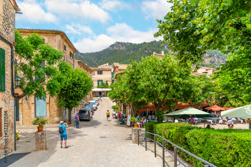 A picturesque street of shops and cafes in the medieval village of Valldemossa  Spain  on the Mediterranean island of Mallorca. 