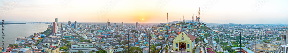 Panoramic photo of the view of Guayaquil from the top of the lighthouse on the Cerro Santa Ana (Saint Ana hill), a moment before sunset after a warm sunny summer day. Ecuador.
