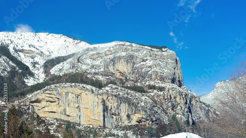 Horizontal Timelapse of a snowy mountain in the Pyrenees on a sunny and windy day