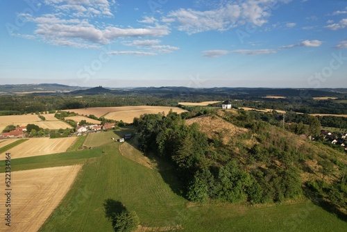 Vysker hill with chapel on the top of the hill,village in Liberec Region,Vyskeř,Czech rpeublic,Europe,aerial panorama landscape view, sunset, scenic panorama photo