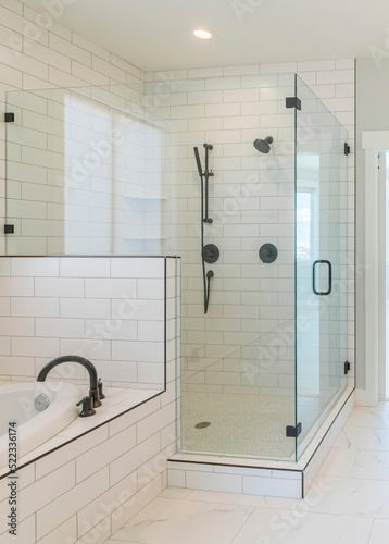Vertical Contemporary master bathroom interior with marble tile flooring and a view of a room