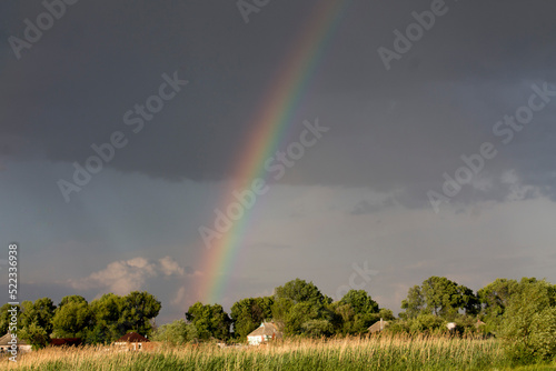 Rainbow in the black sky after the rain.