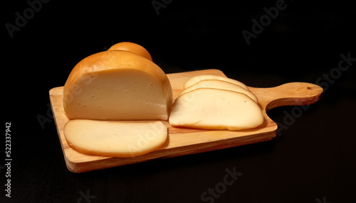 Smoked Scamorza Mozzarella Italian cheese on a wooden board