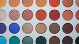 Selective focus of eyeshadow palette with various colors in pearly and matte closeup